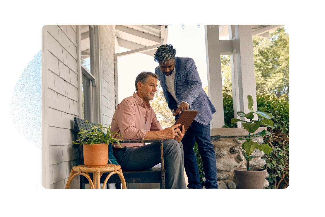 two people sitting on porch talking