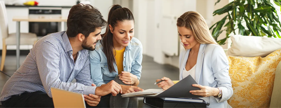 image of three people looking at a phone screen
