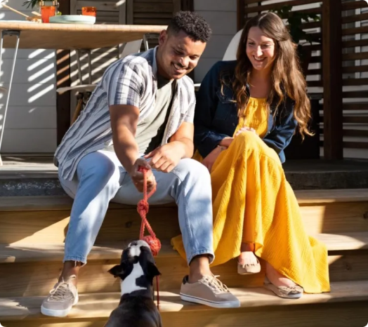 couple on porch with dog
