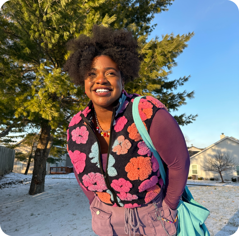 Image of woman with hands in pocket smiling