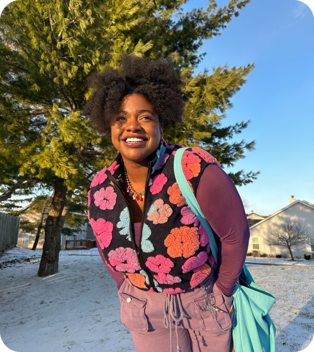 Image of woman with hands in pocket smiling